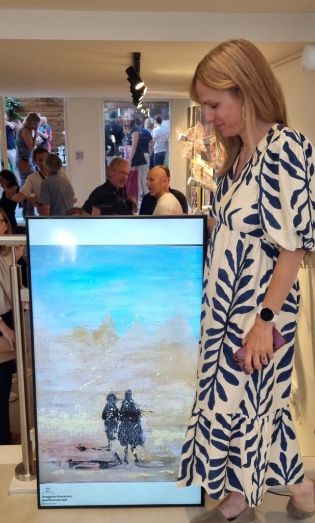 Dragana Stanković with one of her paintings at an exhibition